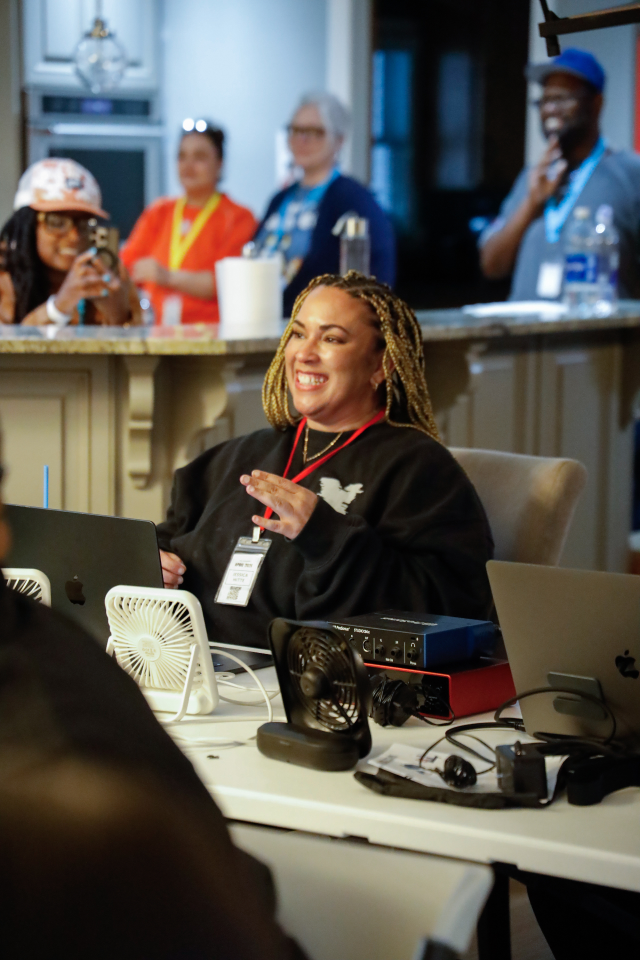 Songwriter at her laptop laughing during a co-write session