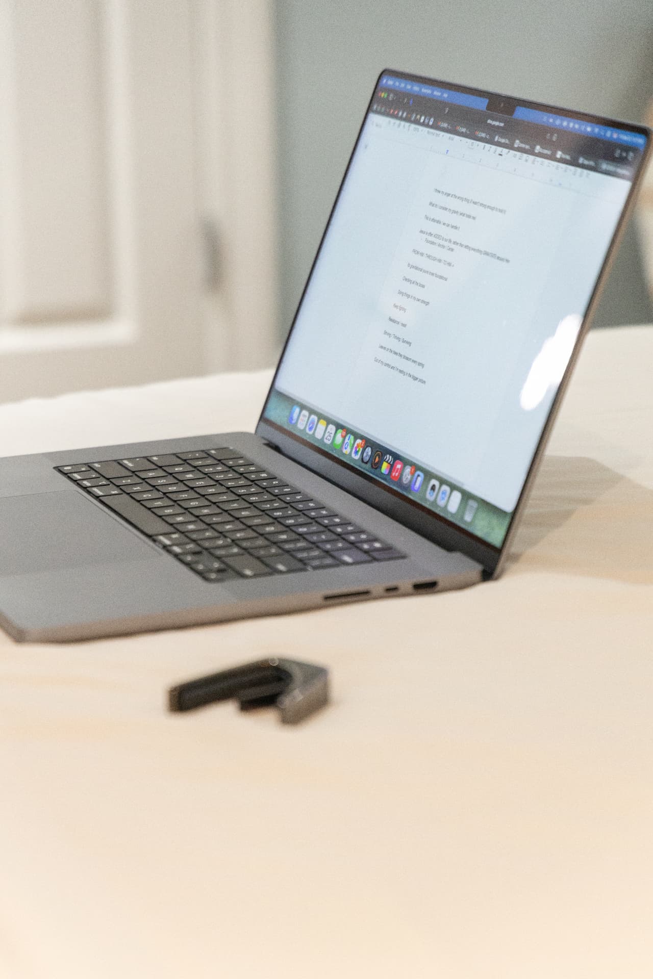 Laptop with an open writing document on a bed