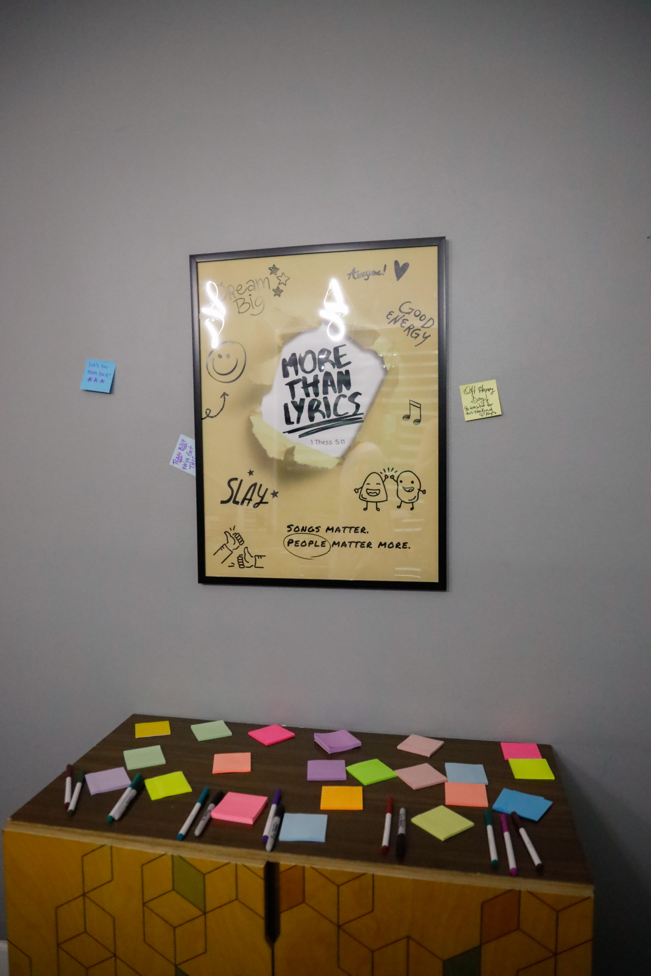 More Than Lyrics note wall with colorful sticky notes and markers