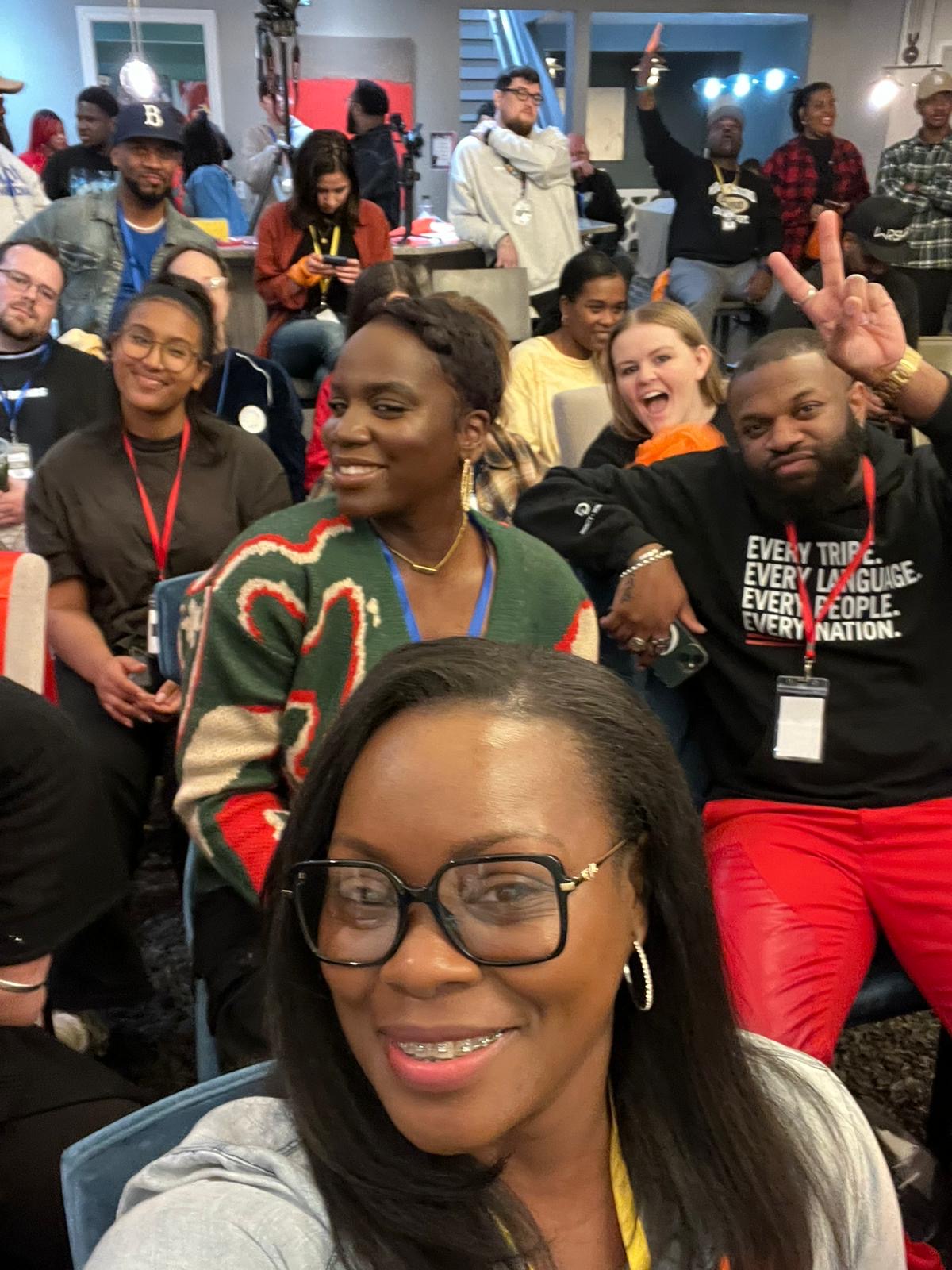 Group selfie of attendees laughing together at a SongShare event