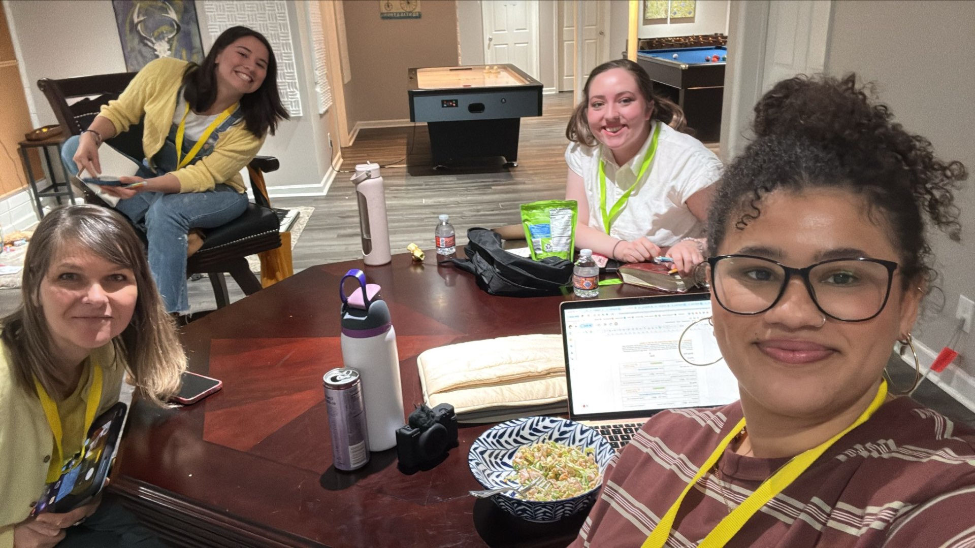 Writers around a table with laptops and snacks