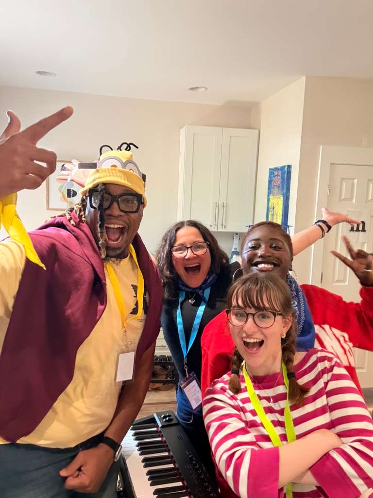 Five friends cheering around a keyboard