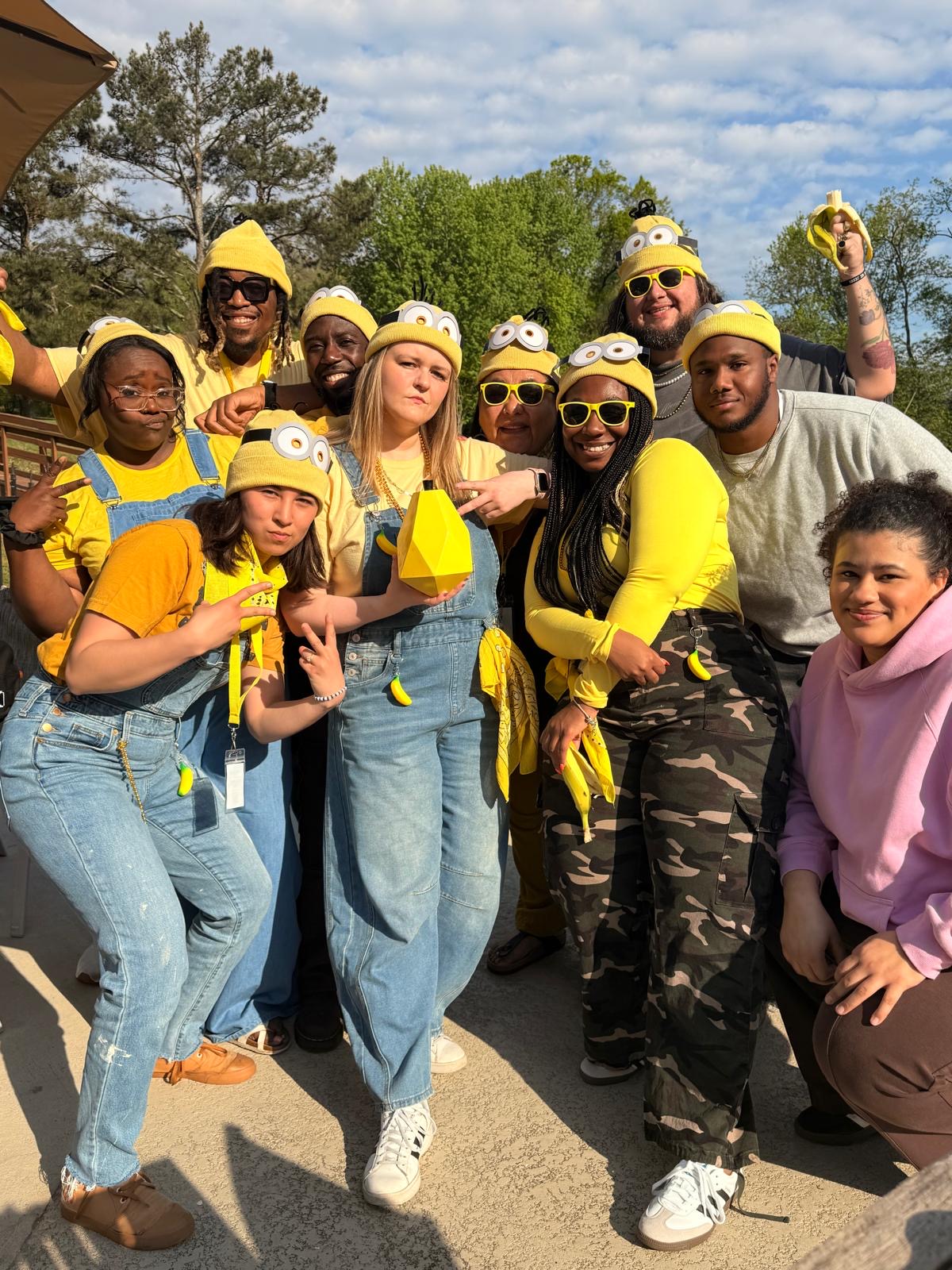 Group dressed in yellow Minion-themed costumes outside