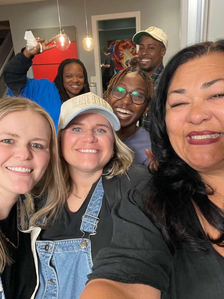 Group selfie of attendees smiling at the eXperience